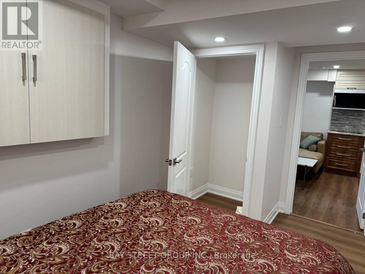 A bedroom with a bed and a cabinet.