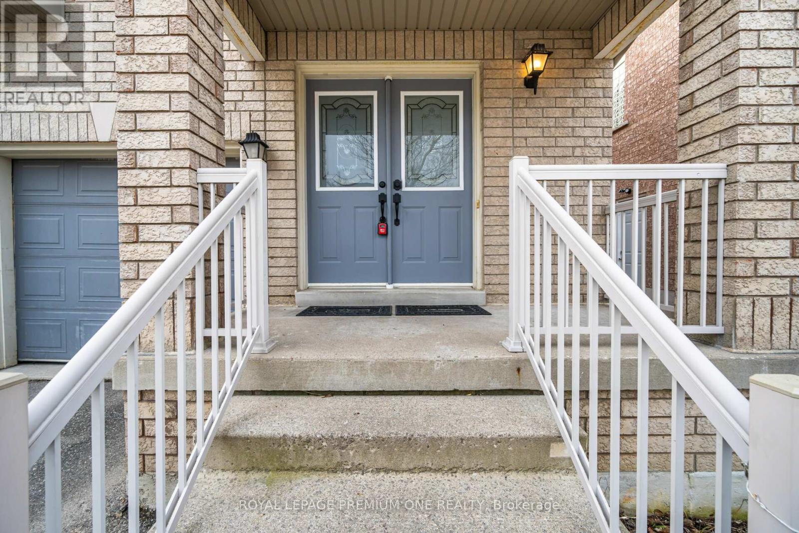 A house entrance with a blue door and white railings.