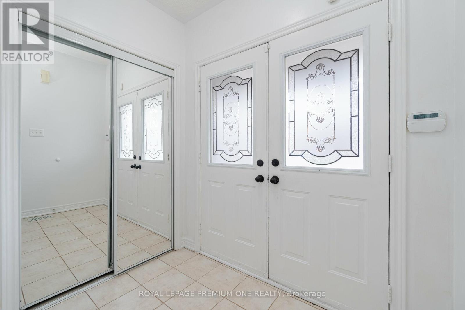 A white door with a glass panel and a handle is shown.