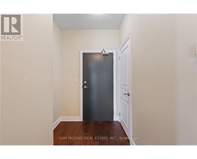 A black door is in the middle of a hallway.