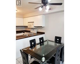 A kitchen with a table and chairs in the foreground.