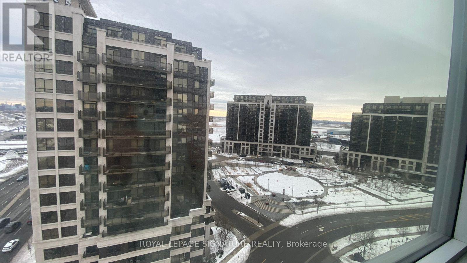 A view from a window of a snowy landscape and buildings.