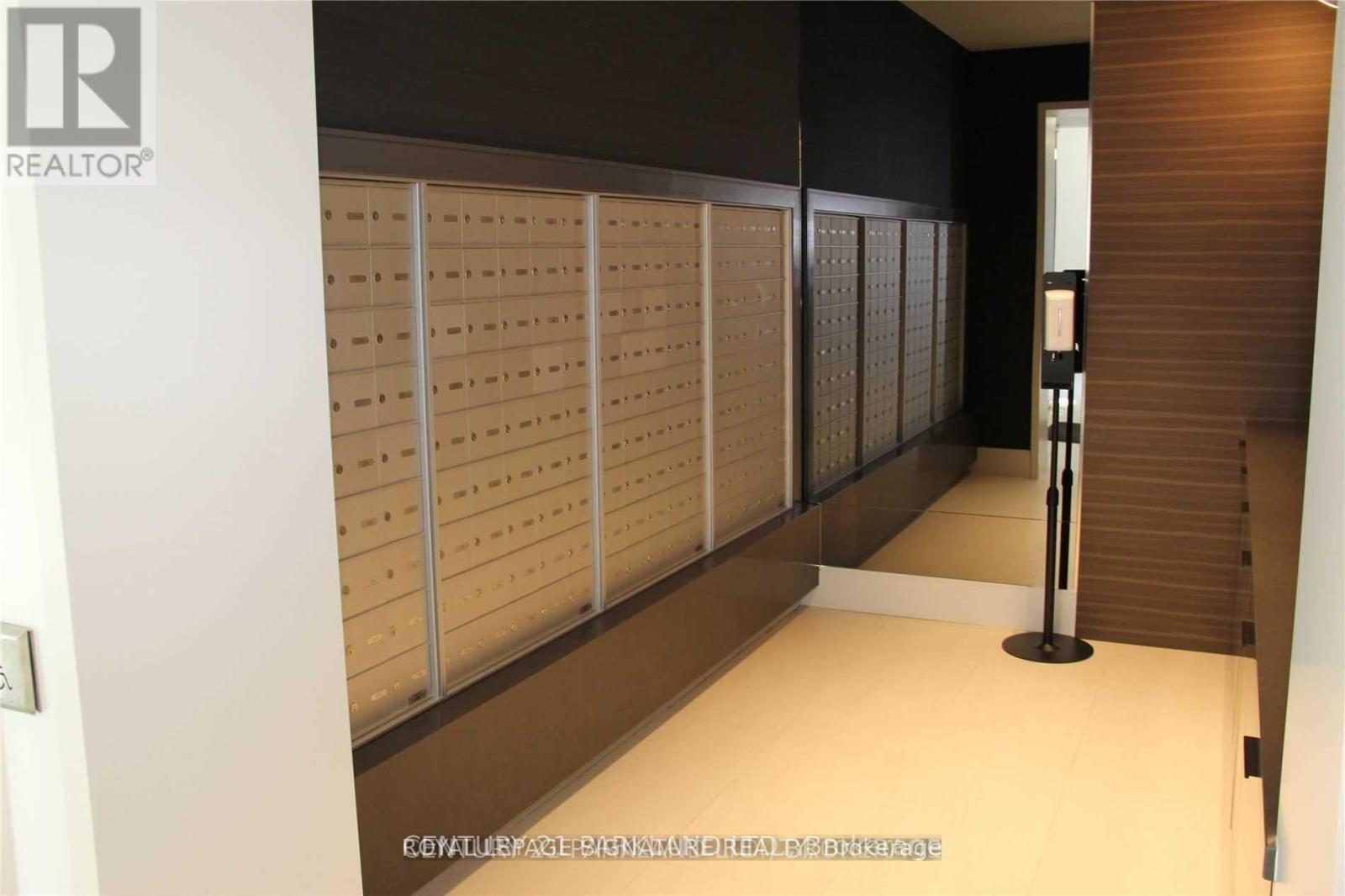 A row of mailboxes are lined up on a wall.