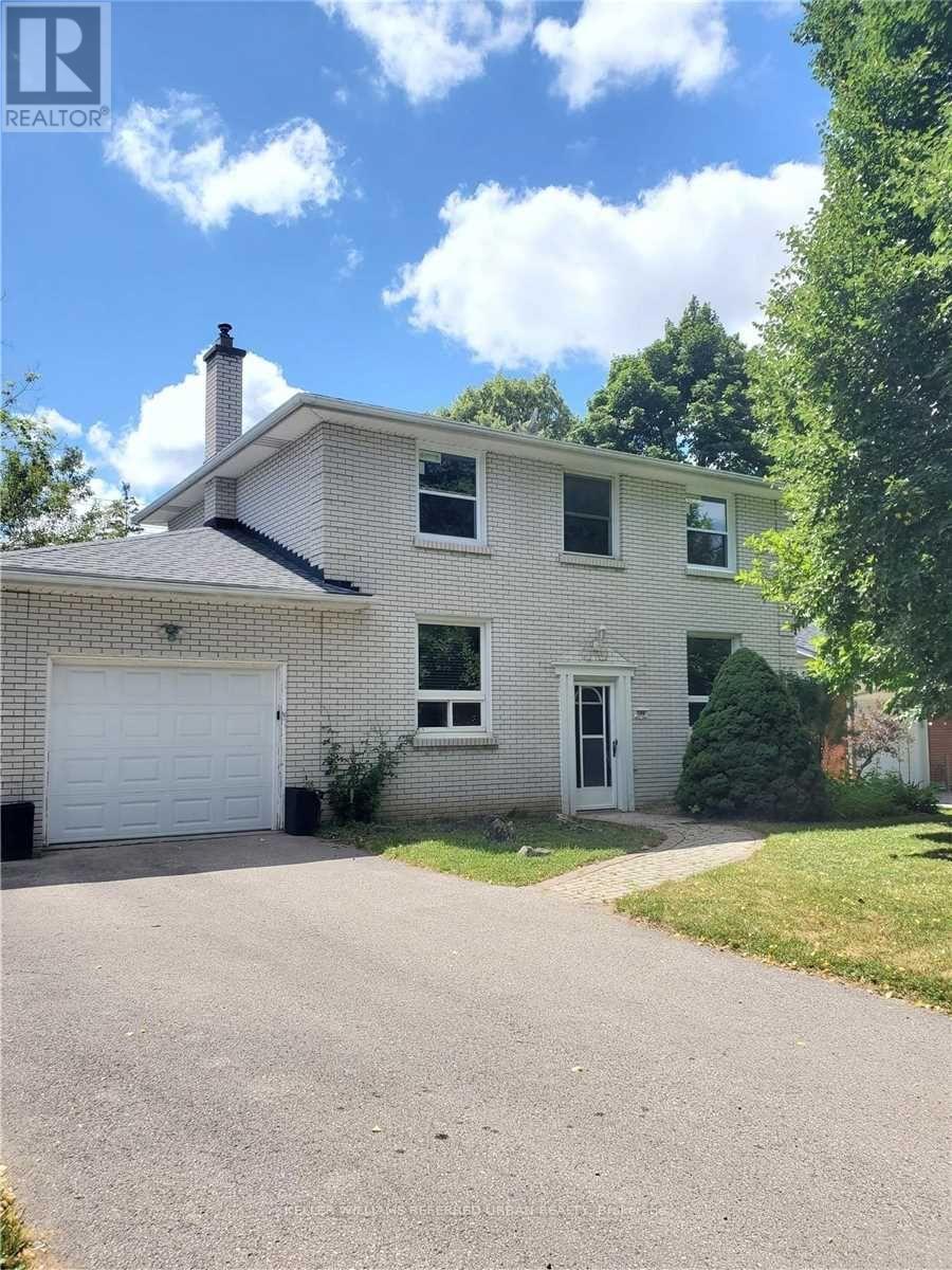 A house with a white garage door and a chimney.