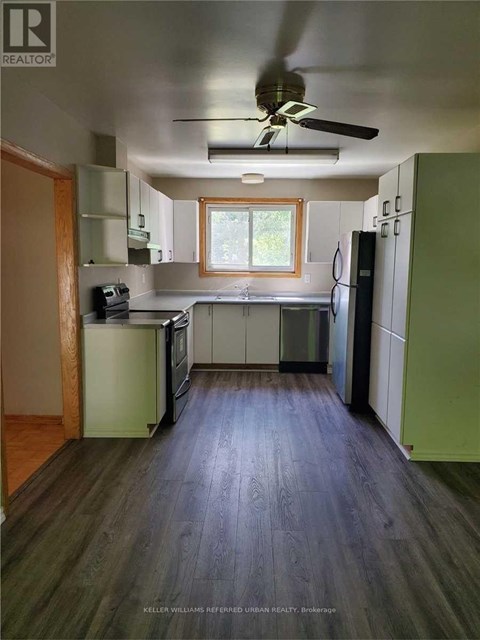 A kitchen with a window above the sink.