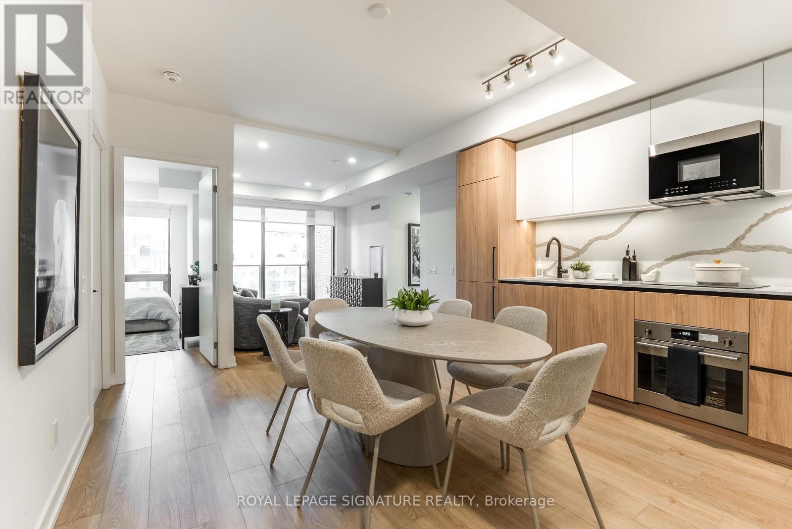 A modern kitchen with a dining table and chairs.