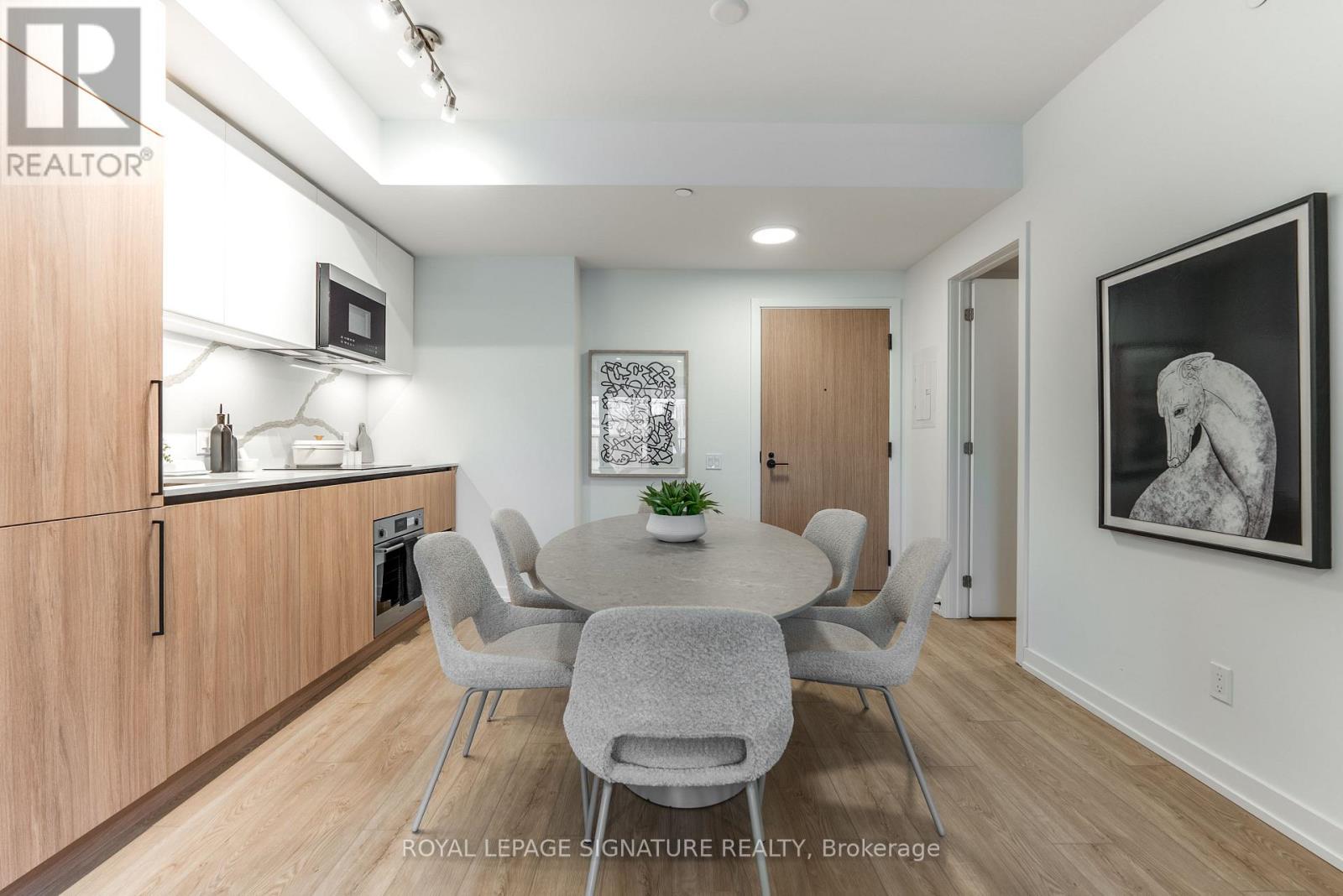 A dining room with a table and chairs.