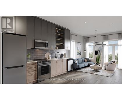 A modern kitchen with a refrigerator on the left and a living room with a couch and a coffee table on the right.
