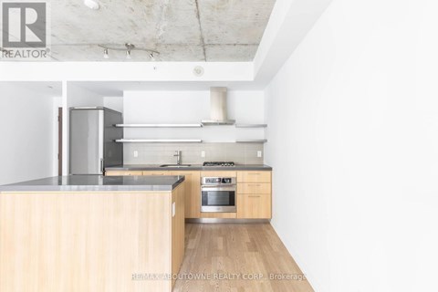 A kitchen with wooden cabinets and stainless steel appliances.