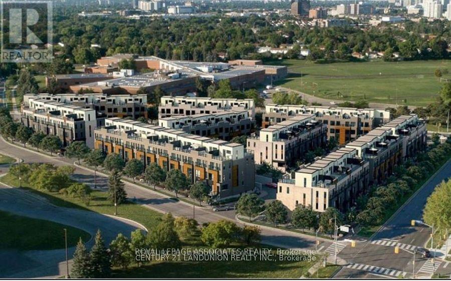 A large building complex with a green lawn in front.
