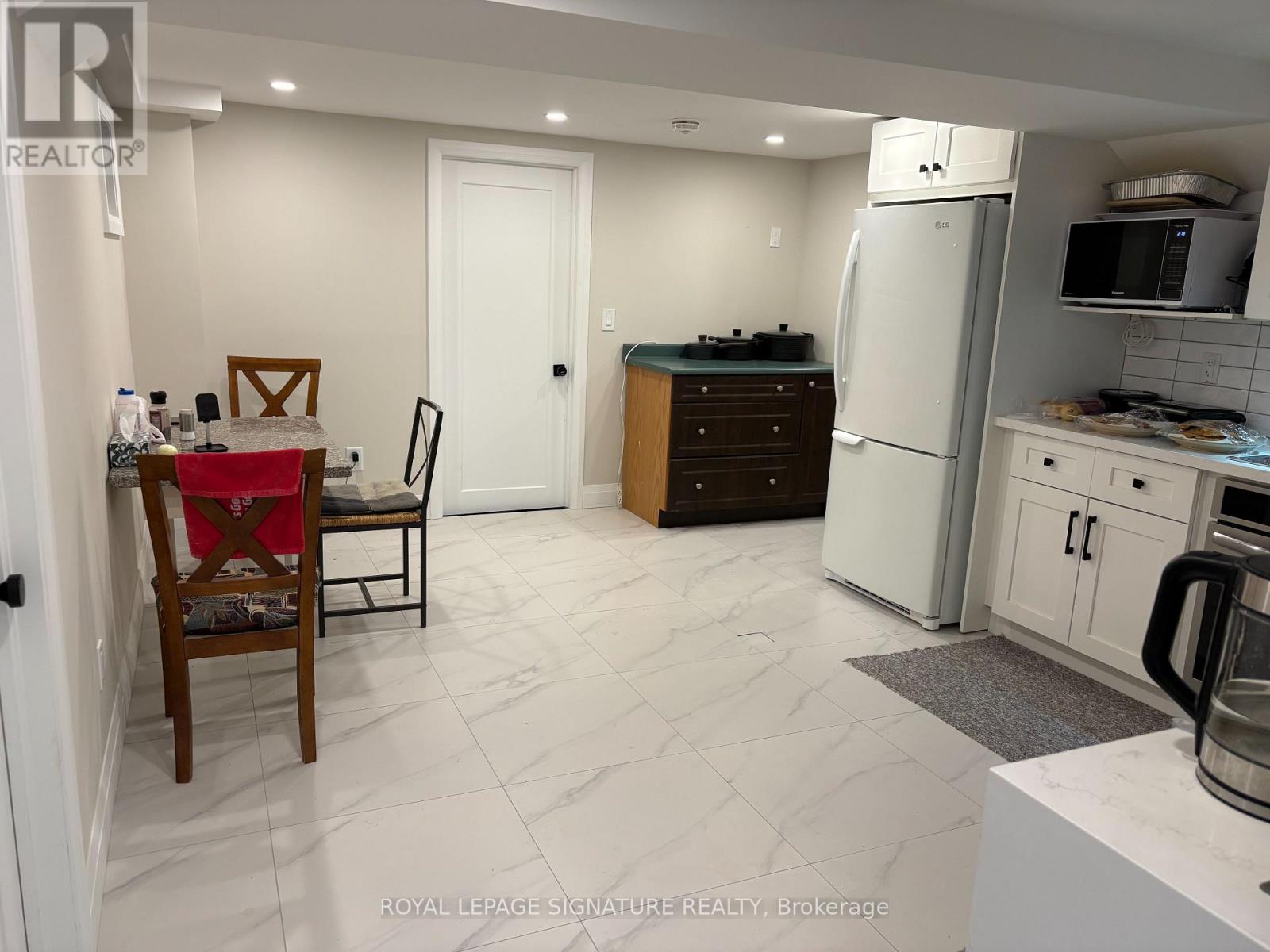 A kitchen with a table and chairs in it.
