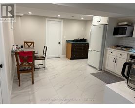 A kitchen with a table and chairs in it.