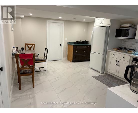A kitchen with a table and chairs in it.