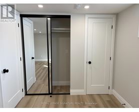 A white door with a glass panel is in a room with a wooden floor.