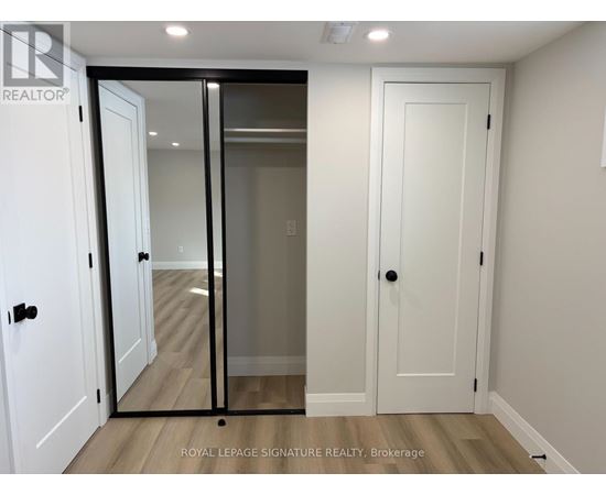 A white door with a glass panel is in a room with a wooden floor.