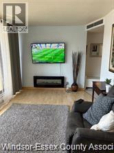 A living room with a television and a fireplace.