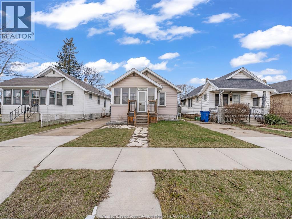 A realtor photo of a house with a front yard and a fence.