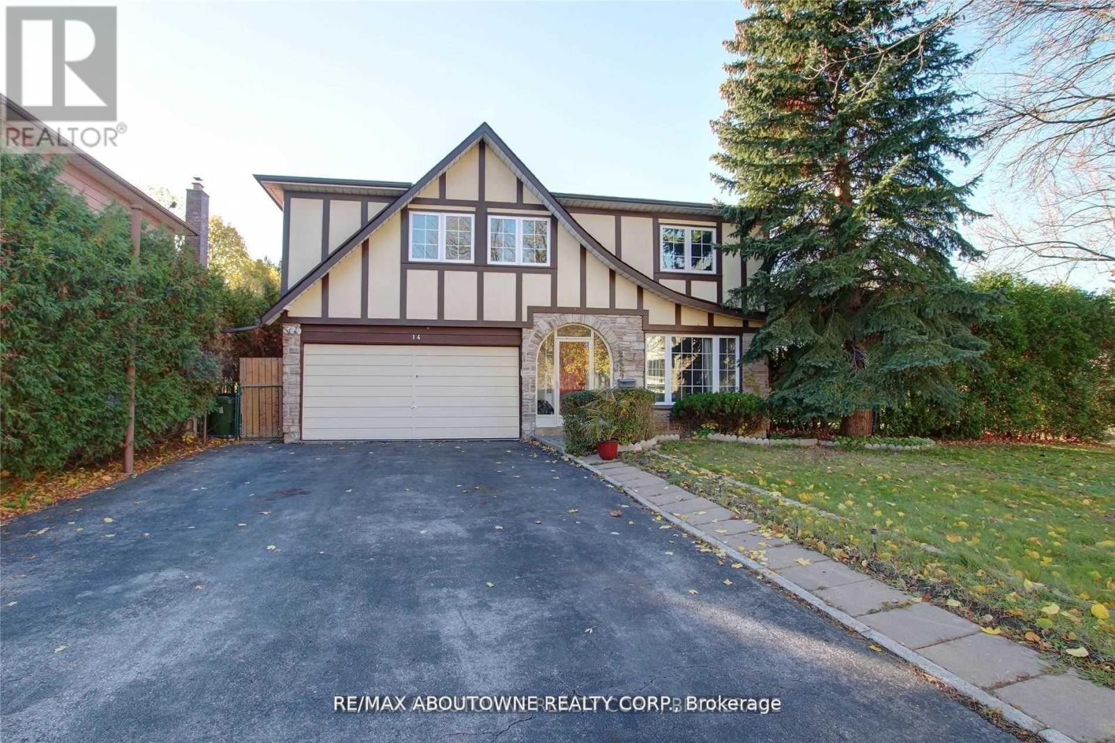 A house with a garage and a driveway is for sale.