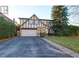 A house with a garage and a driveway is for sale.