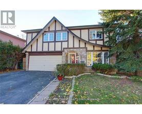 A house with a brown and white facade is for sale.
