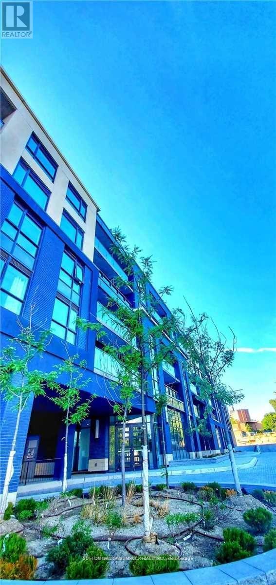 A modern blue building with trees in front.