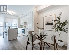 A modern kitchen with a glass table and chairs.