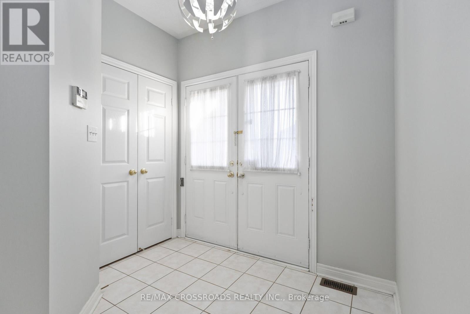 A white door with a window above it in a room.
