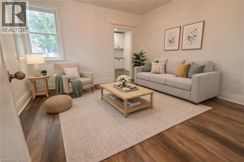 A living room with a grey couch, a wooden coffee table, and a rug.