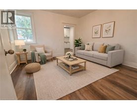 A living room with a grey couch, a wooden coffee table, and a rug.