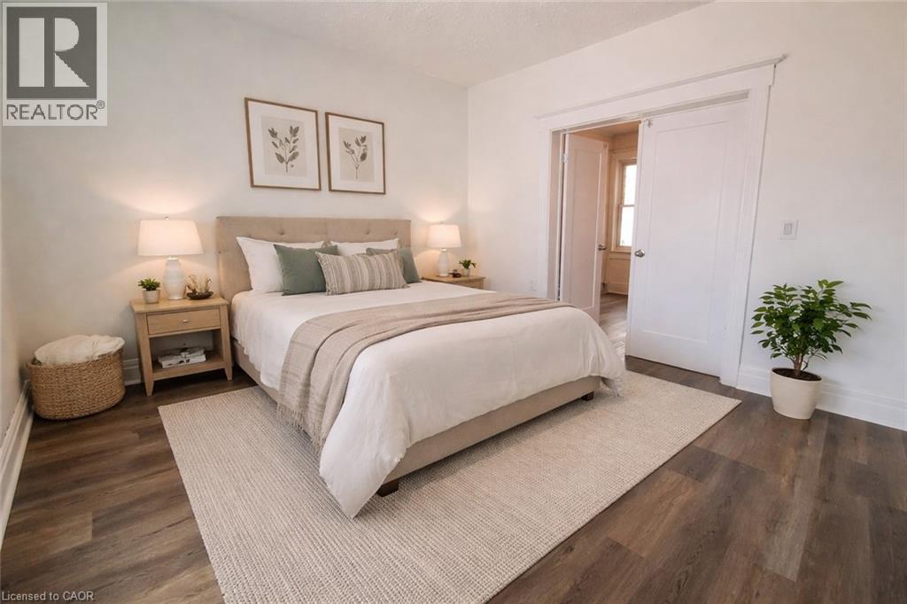 A bedroom with a large bed and a plant.