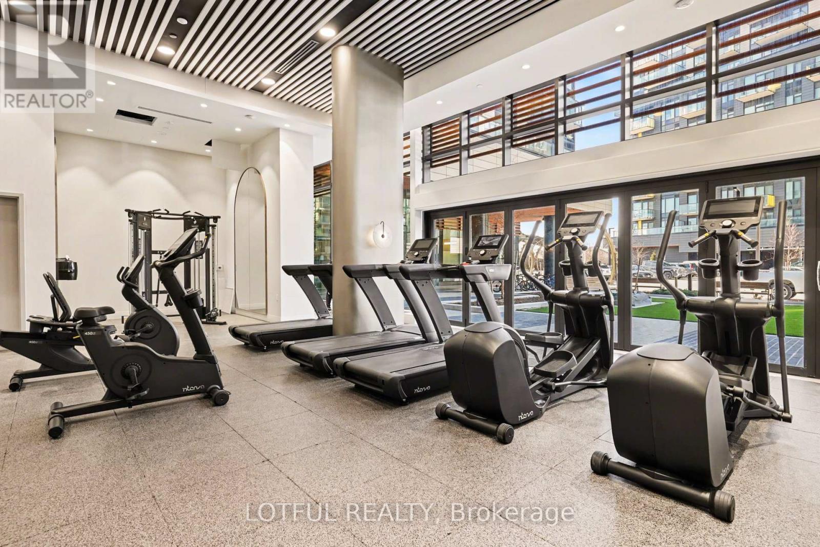 A gym with treadmills, elliptical machines, and other exercise equipment.