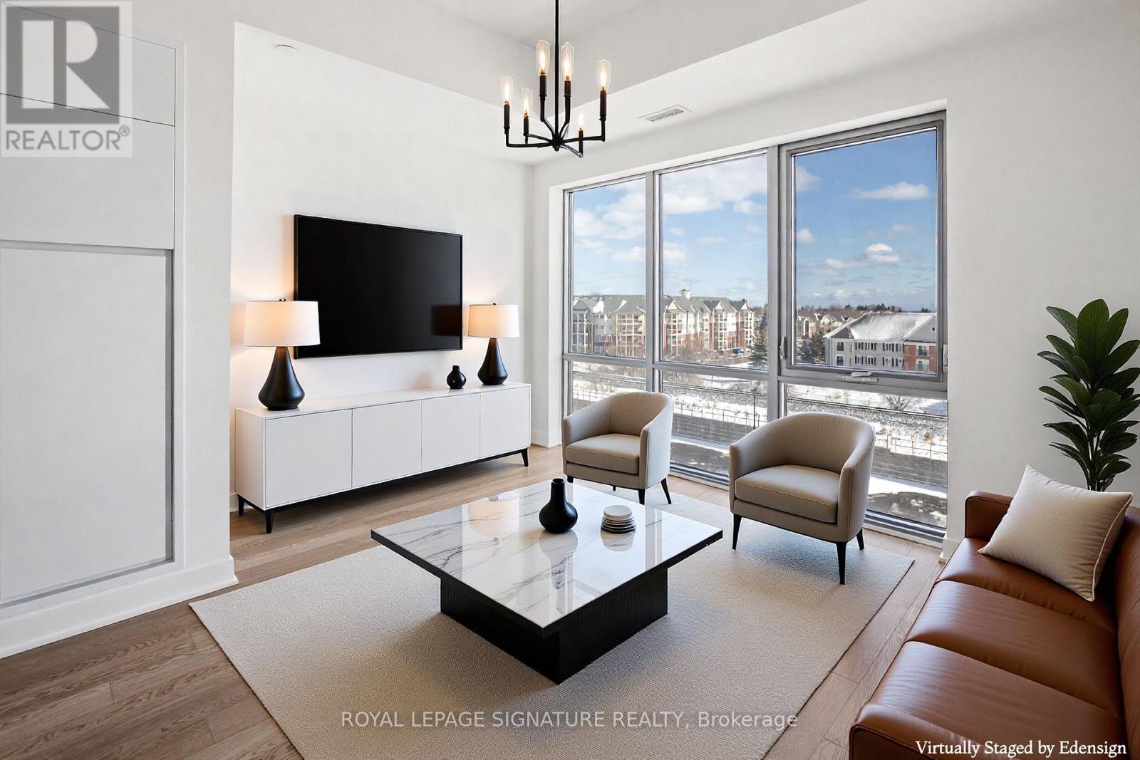 A modern living room with a large window overlooking a cityscape.