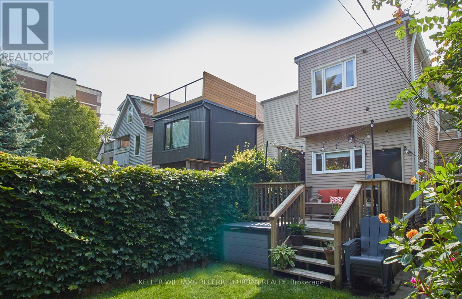 A house with a deck and a hot tub in the backyard.