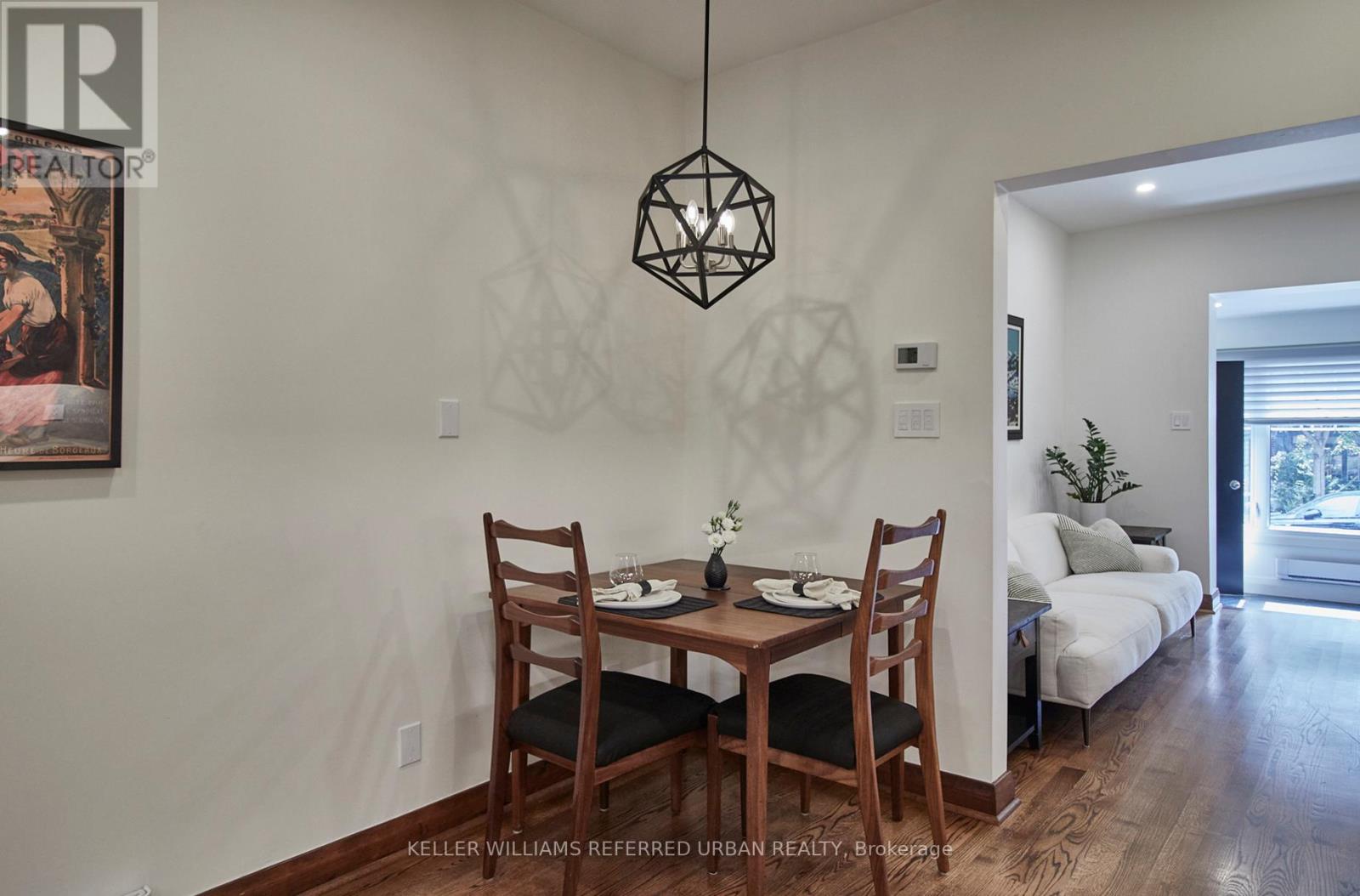 A dining room with a wooden table and chairs.