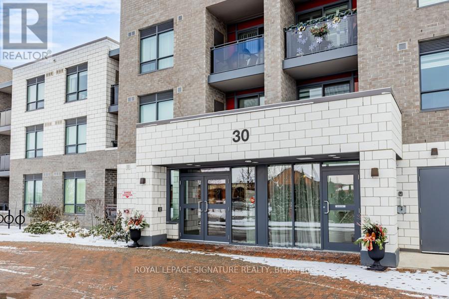 The building is a modern residential complex with a sign that reads "Royal LePage Signature Realty.".