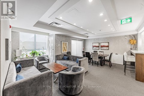 A living room with grey couches and a wooden table.