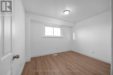 A kitchen with white cabinets and a sink.