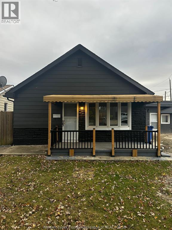 A small house with a porch and a covered entrance.