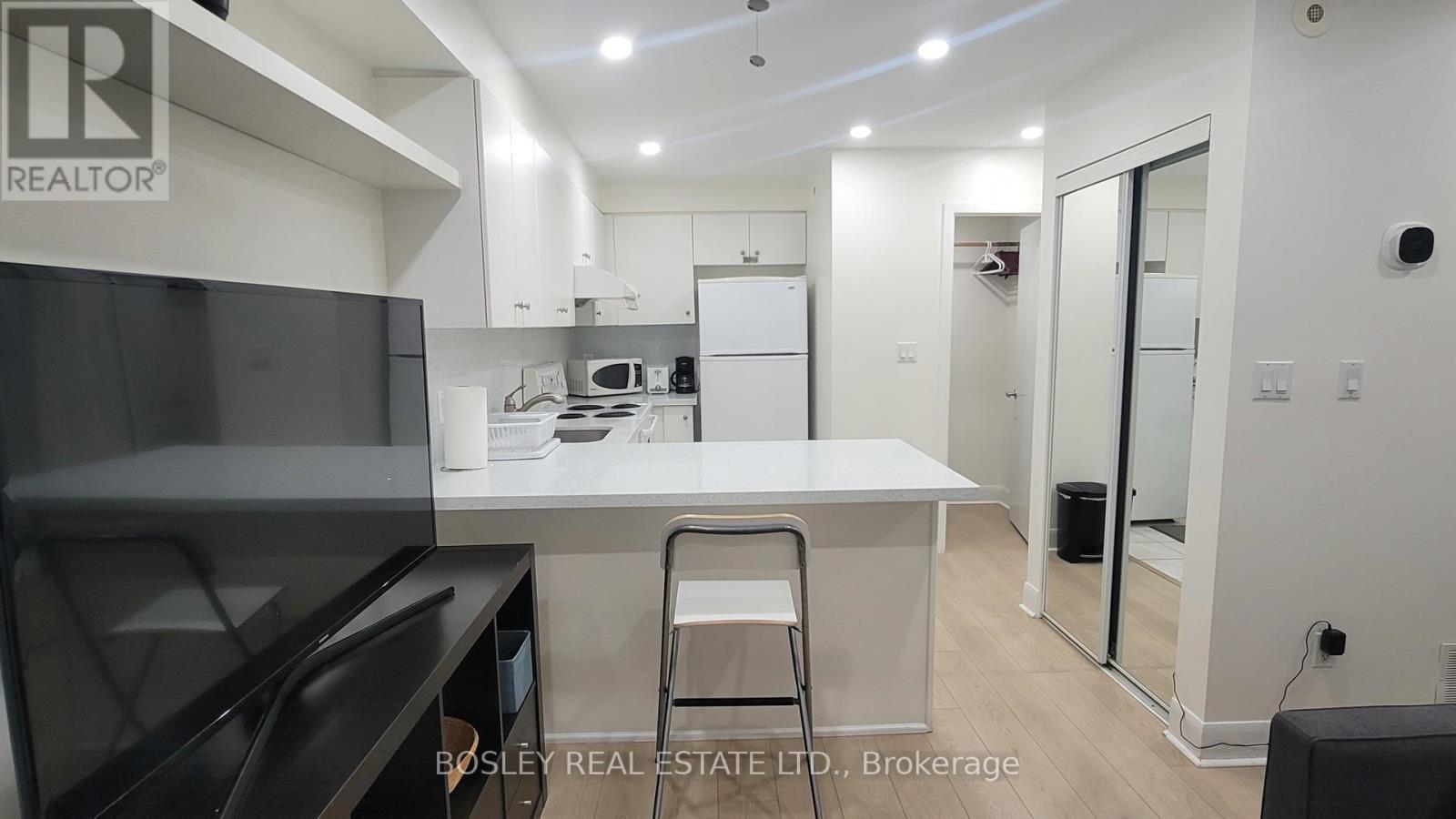 A modern kitchen with a Bosley Real Estate logo.