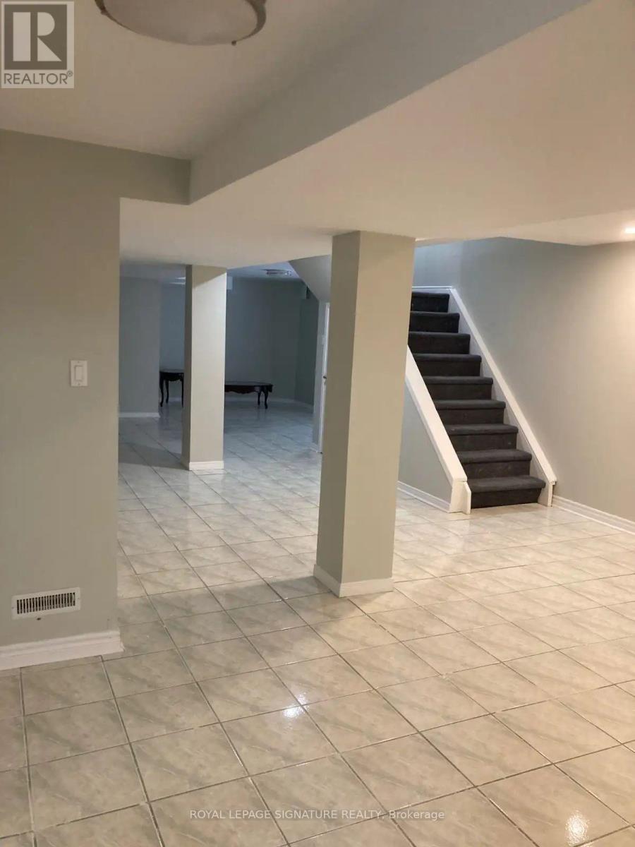 A spacious room with a staircase and a dining table.