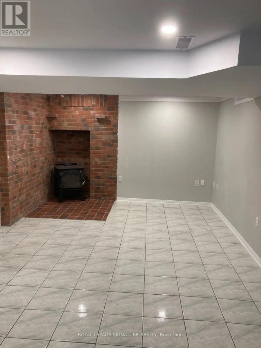 A room with a fireplace and tiled flooring.