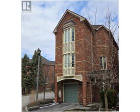 A brick house with a green door and windows.