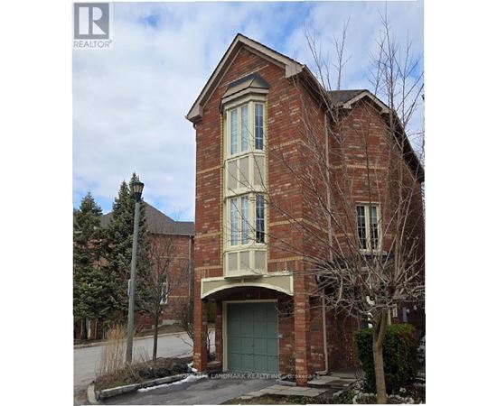 A brick house with a green door and windows.