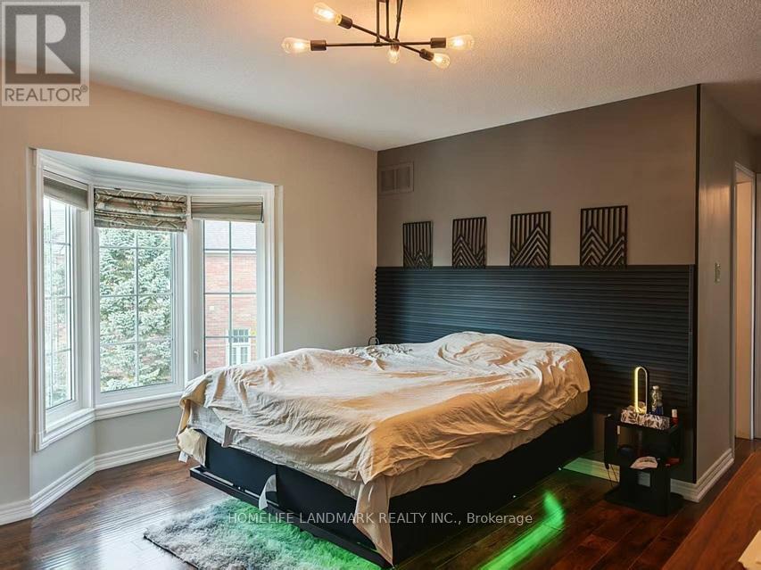 A bedroom with a bed, a window, and a rug.