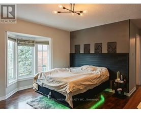 A bedroom with a bed, a window, and a rug.