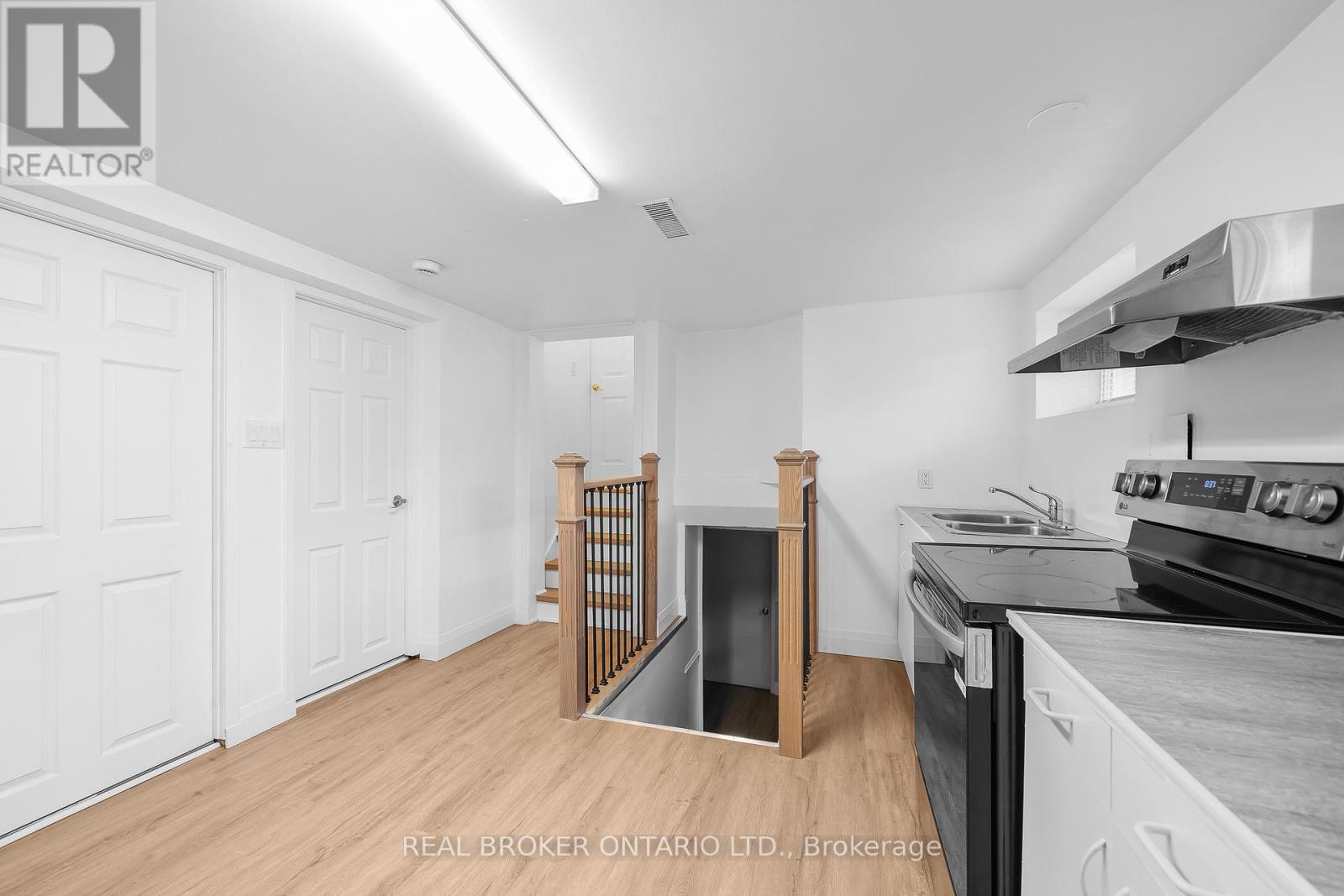 A kitchen with a stove top oven and a sink.