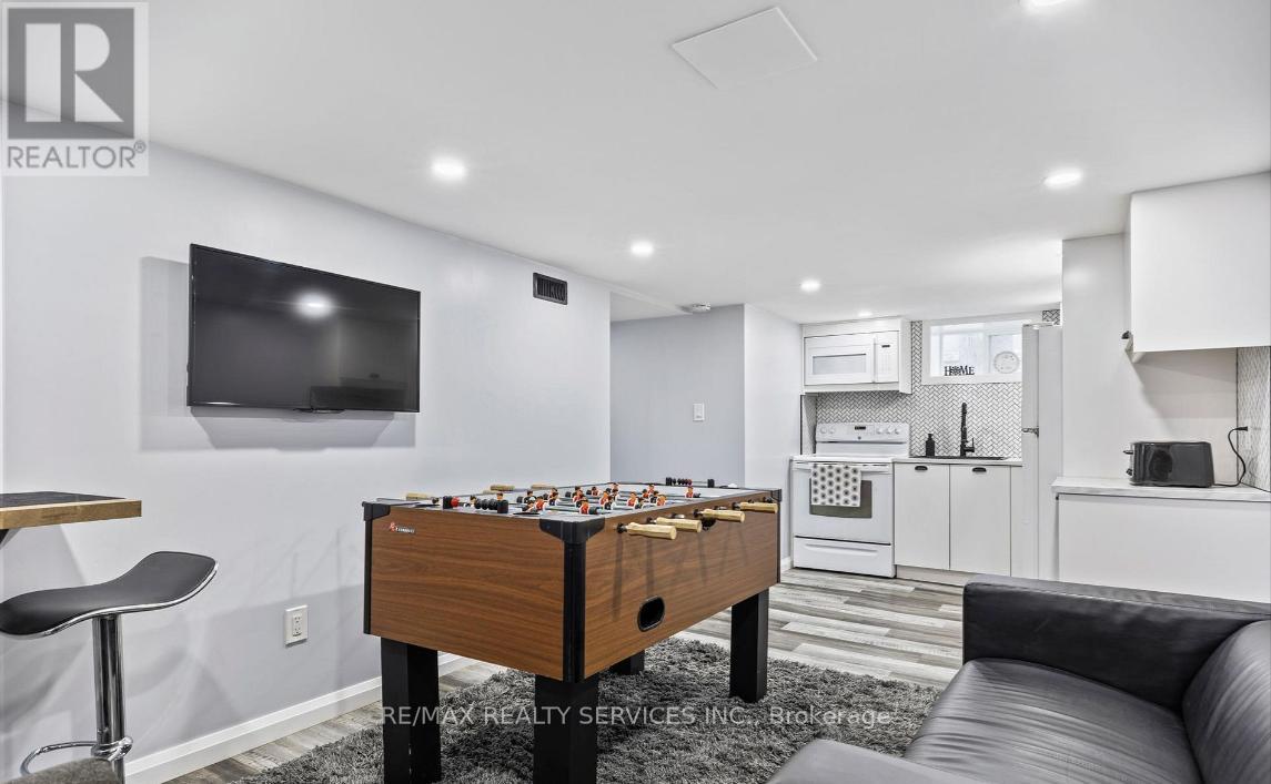 A foosball table is in the middle of a living room.