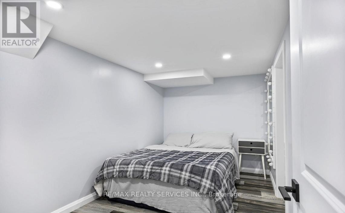 A bedroom with a bed and a ladder.
