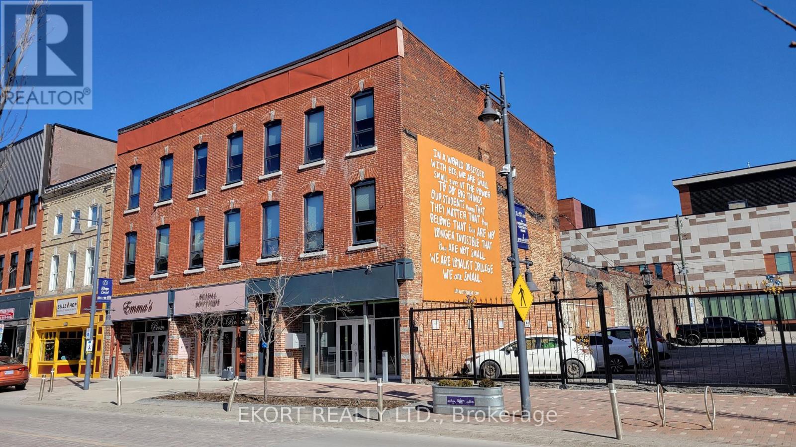 A building with a sign that says "EKORT REALTY LLC Brokerage" on it.