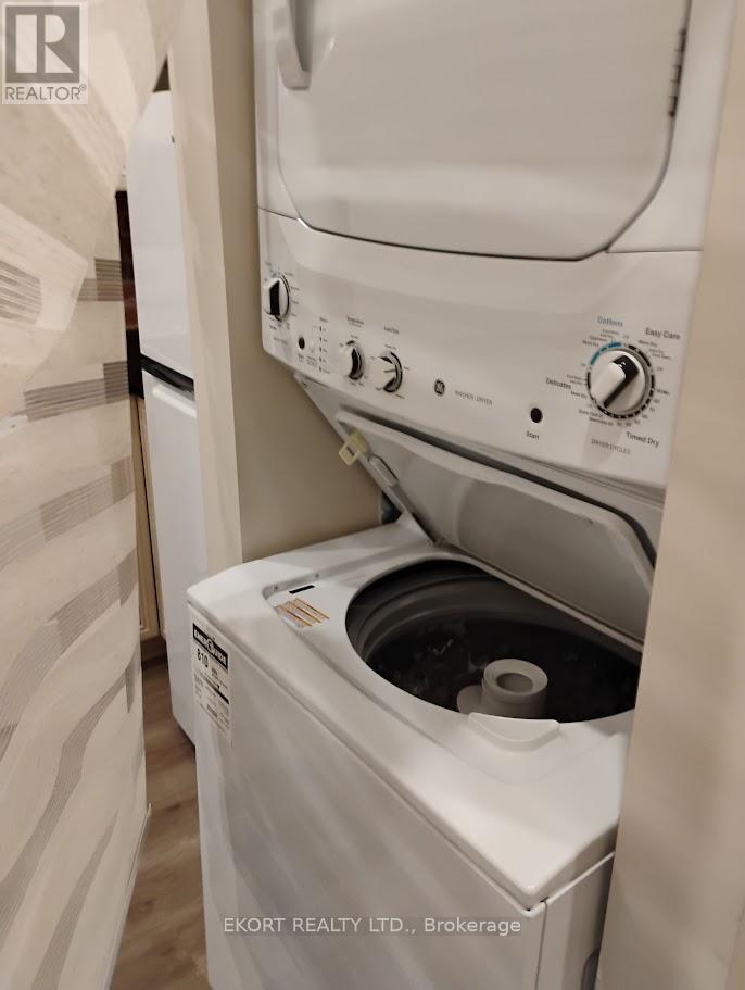 A white washing machine in a laundry room.